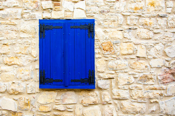 Old Rustic Blue Wooden Window of Stone Built House stock photo