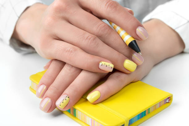 istock Manicured woman's hands holding a pen and notepad 1214208615