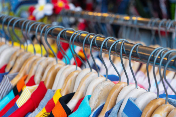 istock Multi-colored t-shirts on a hanger. Clothing store 1214209853