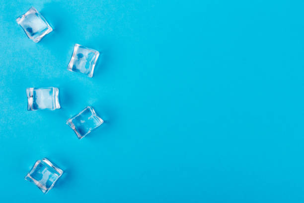 istock ice cubes in close-up on blue background. top view 1214210748