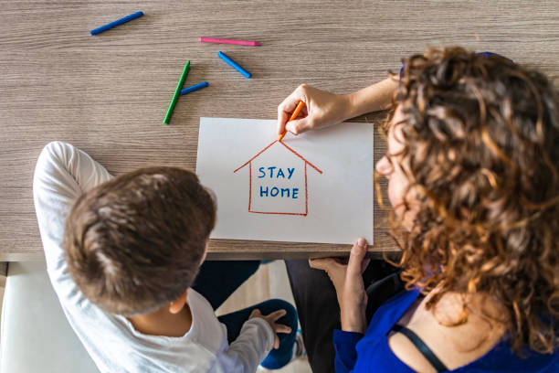 Mother nd son drawing Stay Home logo. Coronavirus concept Mother nd son drawing Stay Home logo. Coronavirus concept stay at home order stock pictures, royalty-free photos & images