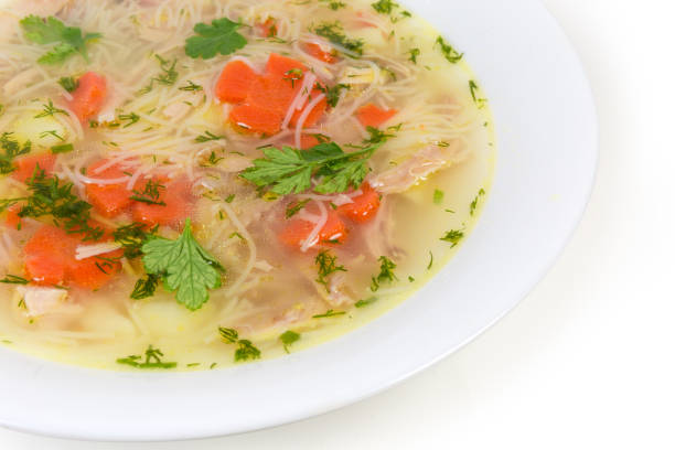 istock Chicken soup with thin short vermicelli in dish close-up 1214219367