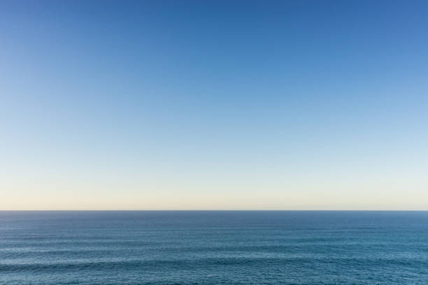 Atlantic ocean and clear sky A calm Atlantic ocean and clear evening sky. light blue sky stock pictures, royalty-free photos & images