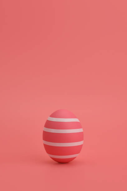 istock Pink Easter egg with white stripes stands against pink background. 1214219643