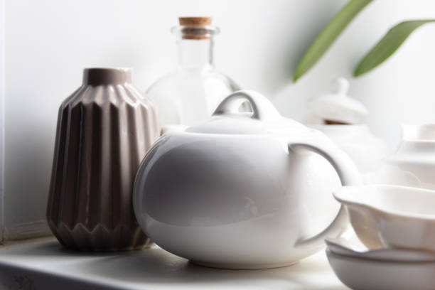 istock teapot, vase, bottle, pots and cups on kitchen  table 1214220427