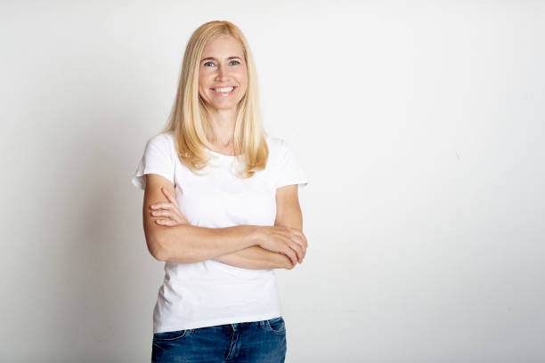 istock Emotional middle-aged woman smiling at grey studio 1214220599