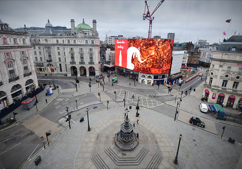 The empty but normally grid-locked Piccadilly Circus in the heart of London's West End, on a weekday lunchtime. Iconic London locations empty at the start of the Corona Virus pandemic