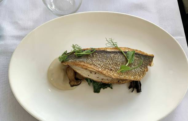 istock Fine dining, grilled fish fillet on mushrooms and herbs 1214221268