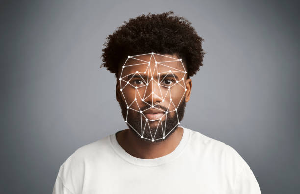 istock Facial recognition. African American man with polygonal mesh on his face against grey background 1214222455