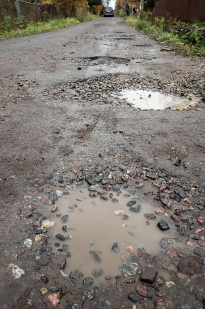 istock Dirty rural road with puddles and mud 1214223981