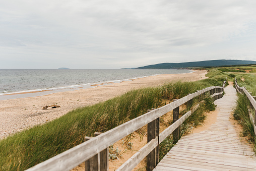 Wood boardwalk at Inverness Beach on the west coast of Cape Breton Island fronting the Gulf of St. Lawrence, Nova Scotia, Canada