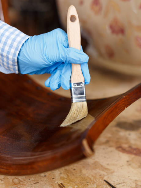 istock Hand varnishing vintage chair 1214228556