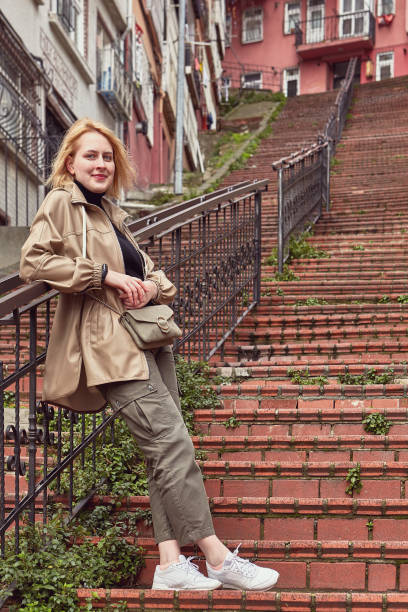 Woman traveler resting before climbing stairs.