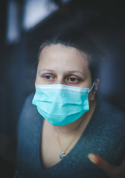 istock Surgical protection mask on woman's face 1214231173