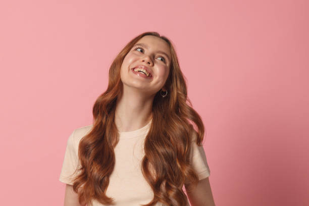istock cheerful female with funny mood isolated on pink background 1214231999