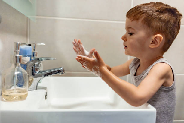 istock Little boy washing his hands 1214232891