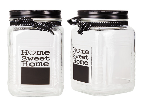 Empty glass jar with black metal lid decorated with words \