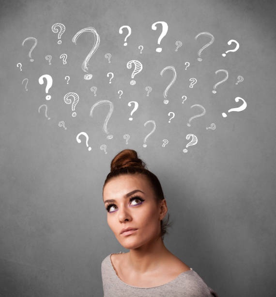 istock Young woman with question marks above her head 1214233876