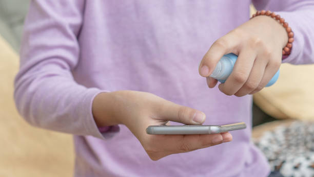istock Use hand sanitizer to clean the phone 1214233957