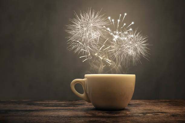 A cup with fireworks over it A white cappuccino cup is sitting on a rustic wooden surface. A miniature display of fireworks is lighting up the scene right above the cup. Concept for great taste and aroma. tasse café stock pictures, royalty-free photos & images