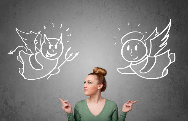 istock Woman standing between the angel and the devil 1214235705