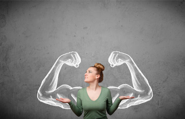 istock Young woman with strong muscled arms 1214236870