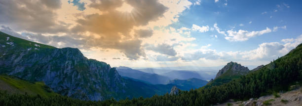 istock Panorama of mountain ranges in sunlight 1214237120