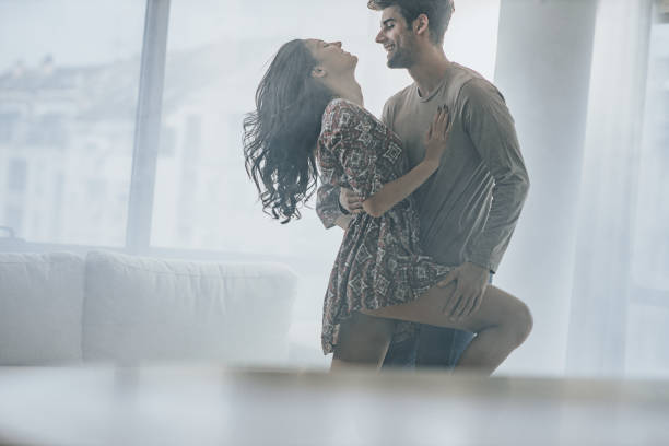 istock Happy couple having fun while dancing in the living room. 1214237765