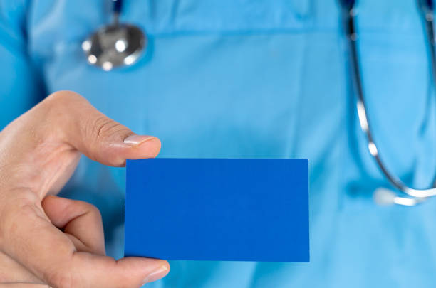 istock Doctor hand holding blank calling card 1214243570