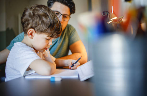 istock Farther Helping Son to finish his Homework 1214246014