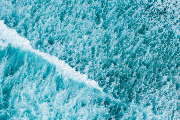 istock Big ocean waves hitting a coral rif. View from above. 1214248439