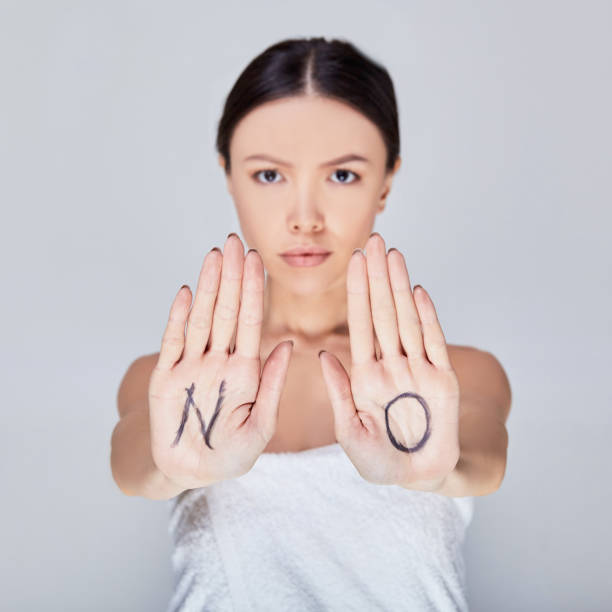 istock Woman expressing denial with NO on her hand. 1214249631