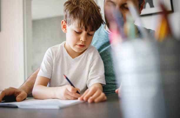 istock Farther Helping Son to finish his Homework 1214249738