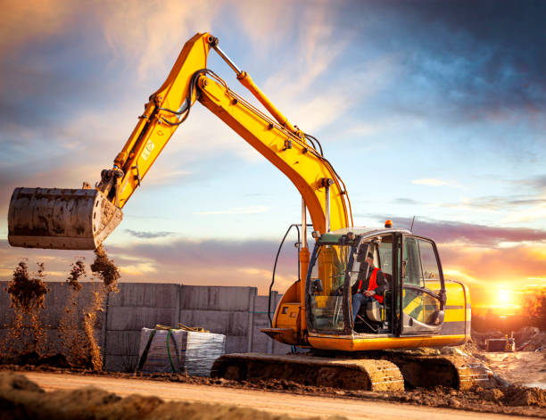 istock Excavator at a construction site against the setting sun 1214250244