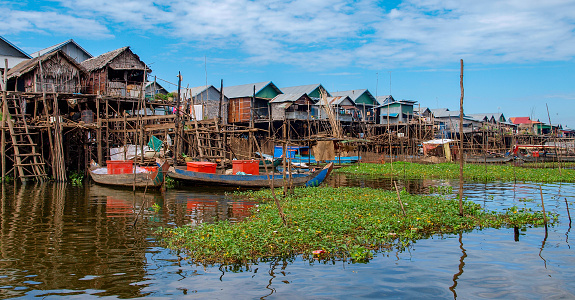 Simple bamboo houses built in the water of Tonle Sap Lake near Siem Reap in Cambodia