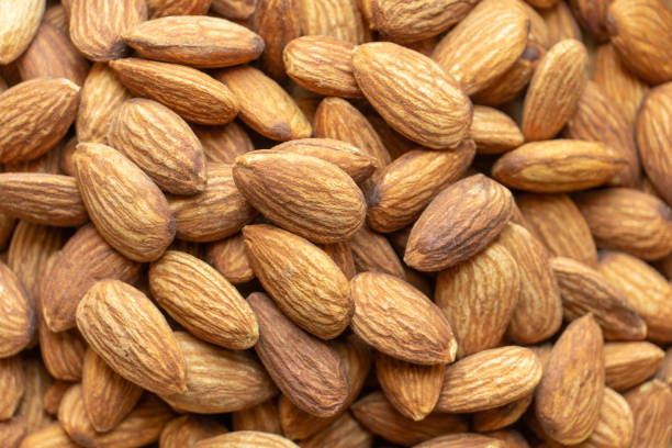 istock Almonds in brown wooden bowl 1214253003