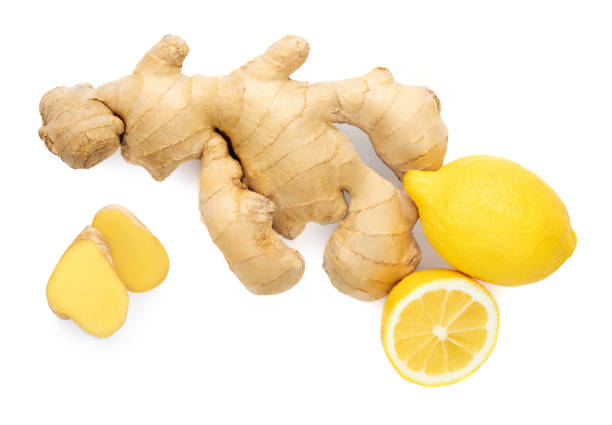 istock Fresh ginger root  with sliced and lemon fruit  isolated on white background. Top view. Flat lay. 1214253514