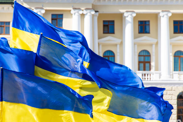 istock Ukraine flags evolving on a wind government main building architecture facade with columns , independence concept background picture 1214253790