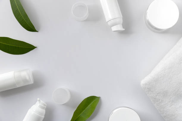 istock Cosmetic cream, towel and leaves on white background 1214258849