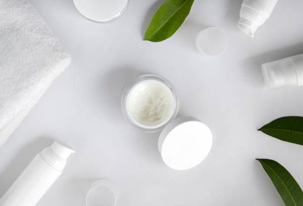 istock Cosmetic cream, towel and leaves on white background 1214258888
