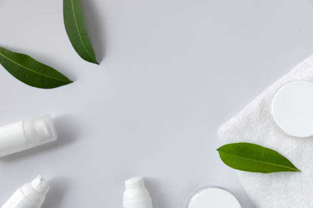 istock Cosmetic cream, towel and leaves on white background 1214258935