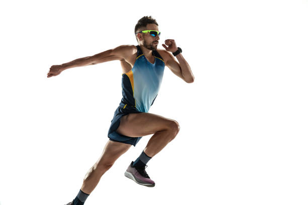 istock Triathlon male athlete running isolated on white studio background 1214259984