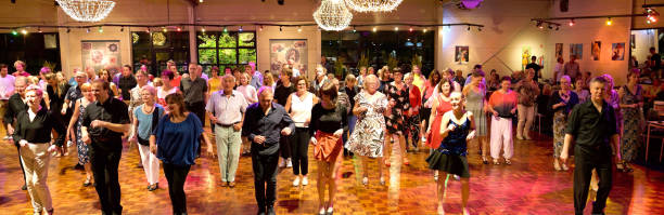 Workshop classes. Indoor line dancing by a professional instructor. Herent, Belgium - September 14, 2019: Open House indoor dancing classes evening show. Photo reportage open door promotion indoor dance classes. Courses starting half September. Teacher in front of group demonstrates solo dance. Large view on big group of people listening to the dance steps instructions. teacher retirement party stock pictures, royalty-free photos & images