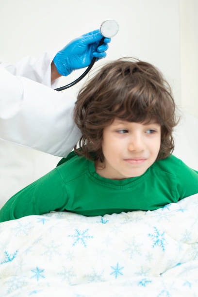 istock Doctor in medical examination using stethoscope on little boy 1214263044