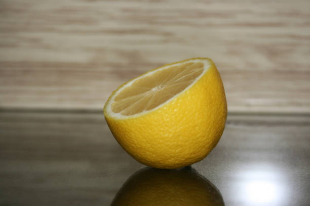 istock a half of lemon on the wooden background 1214263638