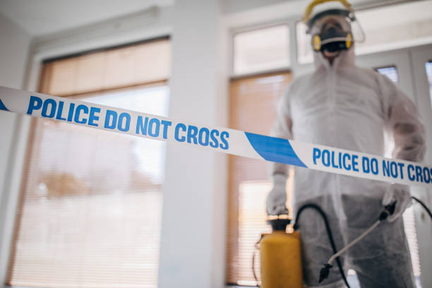istock Man in protective suit disinfecting and spraying coronavirus infected room building 1214263648