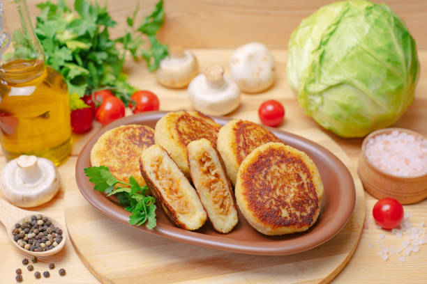 Pies on a wooden board with cabbage