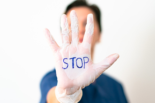 female doctor holding up his hand in a stop gesture