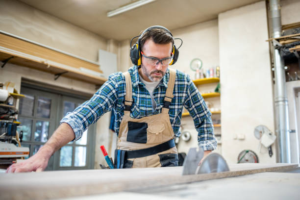 istock Circular saw cutting a wooden board in carpentry workshop 1214265629