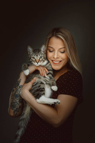 istock Young attractive woman holding cute kitty 1214267463
